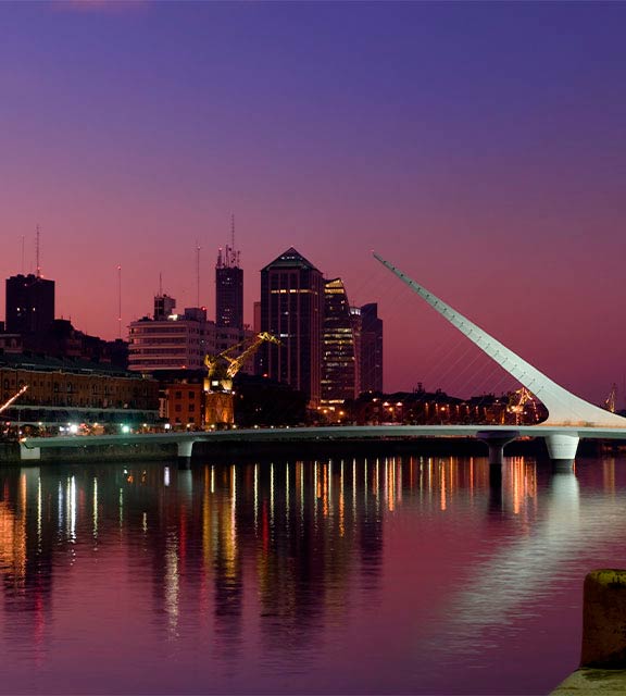 Night falling over the Puente de la Mujer bridge in the Puerto Madero district of Buenos Aires.